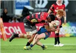  ?? GETTY IMAGES ?? Tasman’s Finlay Christie is tackled by Canterbury’s Billy Harmon in Nelson last night.