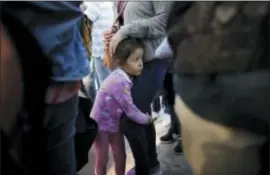  ?? GREGORY BULL — THE ASSOCIATED PRESS ?? Nicole Hernandez, of the Mexican state of Guerrero, holds on to her mother as they wait with other families to request political asylum in the United States, across the border in Tijuana, Mexico.