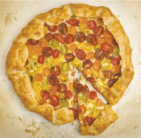  ?? Photos by Russelll Yip / The Chronicle ?? This galette uses cherry tomatoes because their greater skin-to-flesh ratio helps them hold their shape when baked.