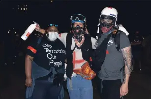  ?? LJ DAWSON PHOTOS KHN ?? Iris Butler, left, stands with two other street medics she worked with during a protest in Denver on June 1. Butler met the other two while attempting to help injured protesters just a few days earlier.