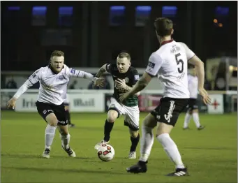  ??  ?? Gary McCabe bursts between Galway United duo David Cawley and Lee Grace.