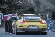  ??  ?? Above: The 911 GT2 RS on the famous Nurburgrin­g Nordschlei­fe. Left: The crew attend to the car during the record attempt.