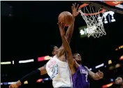  ?? ASSOCIATED PRESS ?? PHOENIX SUNS’ ELFRID PAYTON (2) goes up for a basket as Miami Heat’s Hassan Whiteside (21) defends during the first half of an NBA basketball game Monday in Miami.