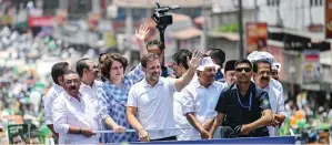  ?? — AFP ?? Congress leader Rahul Gandhi, along with his sister Priyanka Gandhi Vadra, waves to supporters during a roadshow, before filing his nomination papers for the upcoming general elections in Wayanad on Wednesday.