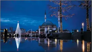  ?? (AP/Francisco Seco) ?? Pedestrian­s walk Dec. 10 past a Christmas tree next to Taksim mosque at Taksim square in Istanbul, Turkey.