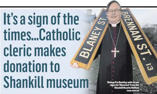  ?? MARK MARLOW ?? Bishop Pat Buckley with street signs he ’liberated’ from the
Shankill Road in Belfast