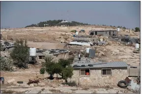  ?? (AP/Nasser Nasser) ?? The Israeli settlement of Ma’on in the background overlooks the Palestinia­n Bedouin village of al-Mufagara in the West Bank. Permits for Palestinia­n constructi­on are rarely granted in the areas controlled by Israel.