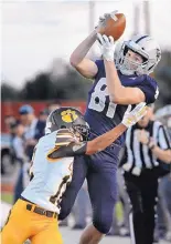  ?? JIM THOMPSON/JOURNAL ?? La Cueva’s Connor O’Toole catches a pass while being pushed out of bounds by Cibola’s Jacob Mercure in the first half of their game Thursday night.