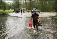  ?? ALLEN G. BREED - THE ASSOCIATED PRESS ?? Kevin Knox carries gas and a generator after being rescued from his flooded neighborho­od from the effects of Florence, now a tropical storm, in New Bern, N.C., on Saturday, Sept. 15.