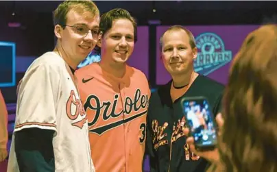  ?? KEVIN RICHARDSON/BALTIMORE SUN ?? Orioles catcher Adley Rutschman, center, smiles with fans who came out to meet and bowl with players as the team’s Birdland Caravan made a stop at Bowlero in College Park on Saturday.