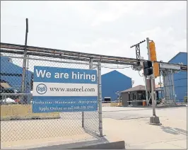  ?? THE ASSOCIATED PRESS ?? A help wanted sign hangs outside the U.S. Steel Granite City Works facility in Illinois. The Labor Department reported that the number of job openings rose to 6.9 million in July.