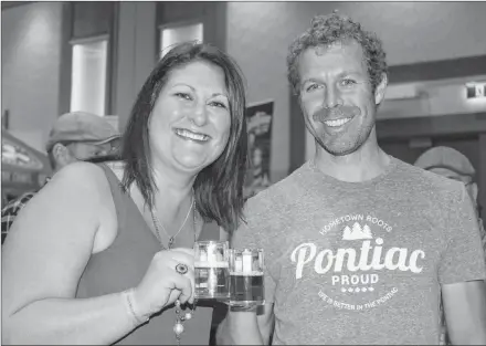  ?? KATHERINE HUNT/SALTWIRE NETWORK ?? Jenna Connolly, left, and Matt Twiddy enjoy some brew from Warfarers’ Ale Craft Brewery while at the 2018 P.E.I. Beer Festival held in Charlottet­own on the weekend.