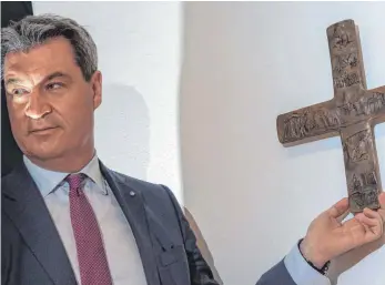  ?? FOTO: DPA ?? Mit diesem Bild wirbt Markus Söder für seine Kruzifix-Offensive. In jeder bayerische­n Landesbehö­rde soll ab dem 1. Juni ein Kreuz hängen.