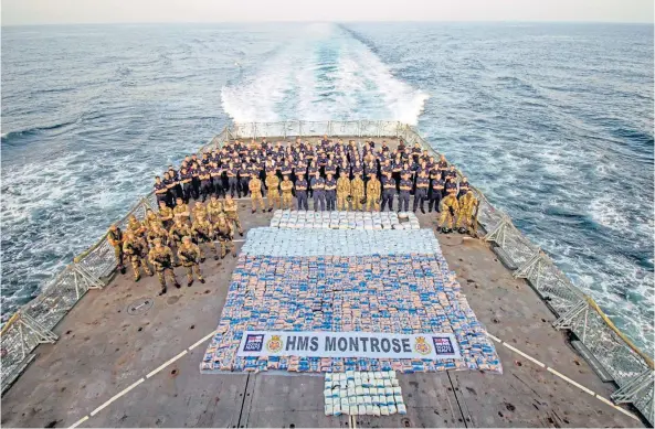  ?? ?? BIG IMPACT: The crew of HMS Montrose gather on deck to show a huge drugs seizure they made while on patrol in the northern Arabian Sea.