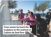  ??  ?? Crew assess by touch the sculpture on the seafront at Colònia de Sant Pere