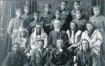  ?? — SASKATCHEW­AN PROVINCIAL ARCHIVES COLLECTION ?? Recruits from File Hills, Sask., pose with elders and a government representa­tive in 1915. About 4,000 First Nations men served in the First World War. After the armistice, they came back to Canada and were still unable to vote.