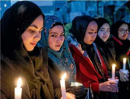  ?? PHOTO: STACY SQUIRES/FAIRFAX NZ ?? Members of the Afghan community of Christchur­ch held a candle-light vigil in Cathedral Square for victims of the Kabul bombing.