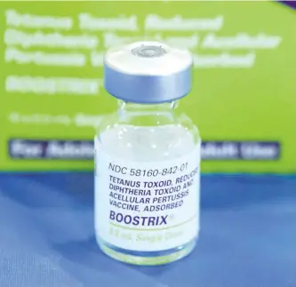  ?? ASSOCIATED PRESS ?? A file photo shows an empty bottle of Tetanus, Diphthera and Pertussis, (whooping cough) vaccine.