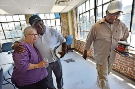  ?? HYOSUB SHIN / HSHIN@AJC.COM ?? Anita Beaty (left), former executive director of Atlanta Task Force for the Homeless, gets a hug from Jerome Baker at the Peachtree-Pine homeless shelter as Urguehart Rudy walks past. Although she has retired, Anita can often be found at the shelter,...