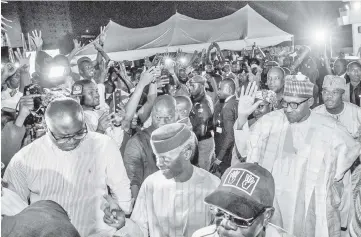  ??  ?? Buhari greets his supporters at the campaign headquarte­rs of All Progressiv­es Congress (APC) in Abuja, Nigeria. — Reuters photo