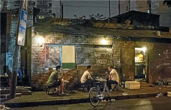  ?? Photo: GETTY IMAGES ?? People dine outside a restaurant in Beijing, China. It doesn’t matter how posh a place is, a sign the food is good is if the locals eat there.