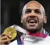  ?? FRANCISCO SECO / AP ?? Lamont Marcell
Jacobs, of Italy, with his gold medal at the 2020 Summer Olympics in Tokyo on Aug. 2, 2021. World Athletics said Wednesday it would pay $50,000 to gold medalists in track and field competitio­ns at the Paris Olympics.