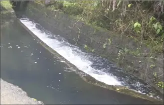  ?? DLNR photo ?? Water flows through a ditch in East Maui. The Environmen­tal Court has temporaril­y reduced the amount of water Alexander & Baldwin and its subsidiary East Maui Irrigation can take from 25 million gallons per day to 20 mgd pending a decision on a contested case hearing by the state land board.