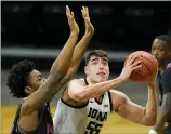  ?? CHARLIE NEIBERGALL — THE ASSOCIATED PRESS ?? Iowa center Luka Garza drives to the basket ahead of Northern Illinois forward Chinedu Okanu during the first half of Sunday’s game in Iowa City, Iowa.