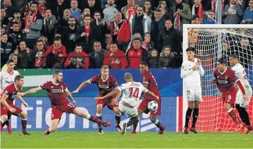  ?? /Reuters ?? Balletic effort: Sevilla’s Guido Pizarro, No 14, scores their third goal and equaliser in stoppage time.