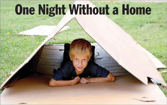  ?? Janelle Jessen/Herald-Leader ?? Wyatt Rhodes tried out the box tent he created to sleep in during One Night Without a Home, held Friday in City Park. The event, sponsored by Genesis House, was designed to raise awareness about homelessne­ss in Siloam Springs. It also served as a...