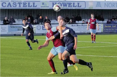  ?? Steve Lewis ?? Colwyn Bay’s Mike Johnson and Llandudno’s Harry Clayton challenge for the ball on Tuesday