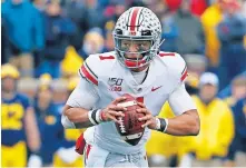  ?? SANCYA, FILE] [AP PHOTO/PAUL ?? Quarterbac­k Justin Fields and Ohio State will open the season in late October and will be scheduled to play nine games.