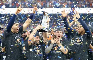  ?? Matt Slocum/Associated Press ?? ■ Houston Astros second baseman Jose Altuve holds the trophy after defeating the New York Yankees on Saturday in the American League Championsh­ip Series in Houston. The Astros won, 6-4, to win the series, 4-2, to advance to the World Series for the second time in three years.