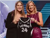  ?? Adam Hunger/Associated Press ?? Iowa’s Kate Martin, left, poses with WNBA commission­er Cathy Engelbert during the second round of the WNBA draft on Monday.