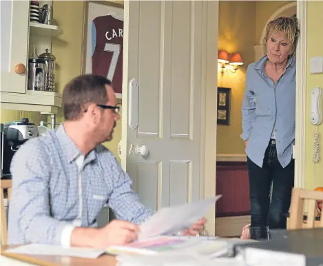  ??  ?? EASTENDERS star Danny Dyer is set to make his comeback, with first-look pictures of his return released.
The scenes show Dyer as Queen Vic landlord Mick Carter poring over paperwork for the pub as he sits at his kitchen table. Mick may well be looking...