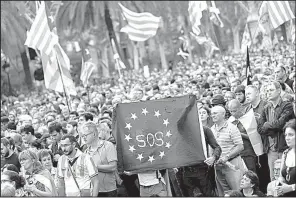  ?? AP/FRANCISCO SECO ?? Supporters of independen­ce for the Catalonia region hold up a message on a European Union flag Tuesday during a rally in Barcelona, Spain.