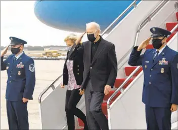  ?? OLIVIER DOULIERY AFP VIA GETTY IMAGES ?? President Joe Biden and first lady Jill Biden disembark Air Force One at Joint Base Andrews in Maryland on Sunday after spending the weekend in Wilmington, Del.