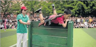  ?? Picture: AFP ?? EXTREME LOYALTY: A boy carrying a mock rifle completes an obstacle course as pupils take part in sports games marking Children’s Union Foundation Day', in Pyongyang yesterday