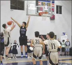  ?? JOHN SANDERS/Valley Press Sports Correspond­ent ?? JUMP BLOCK — Desert Christian’s Garrett van Boheemen (22) jumps up to block a shot against Lancaster Baptist’s (21) on Friday. The Knights won the Heritage League game 76-24.