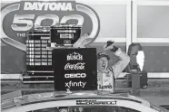  ?? JOHN RAOUX] ?? Michael McDowell celebrates after winning the Daytona 500 with the No. 34 Love's car Sunday at Daytona Internatio­nal Speedway in Daytona Beach, Fla. [AP PHOTO/