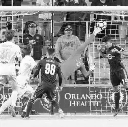  ?? STEPHEN M. DOWELL/STAFF PHOTOGRAPH­ER ?? Orlando City B goalkeeper Earl Edwards Jr., center, stretches to make a save during a match against Louisville City FC at Orlando City Stadium during the 2017 season.