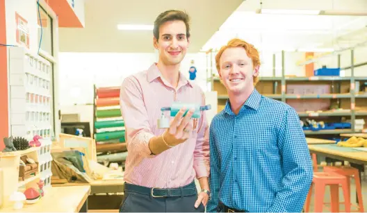  ?? ?? Raleigh Dewan, left, and team partner Mason Morland with Steadispoo­n, which helps patients with Parkinson’s disease eat more easily by mechanical­ly counteract­ing hand tremors.