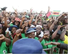  ?? ?? Zanu PF supporters sing and dance as they welcome visiting Belarusian President Alexander Lukashenko at Robert Gabriel Mugabe Internatio­nal Airport in Harare yesterday.