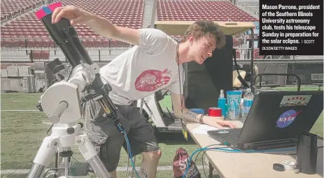  ?? | SCOTT OLSON/ GETTY IMAGES ?? Mason Parrone, president of the Southern Illinois University astronomy club, tests his telescope Sunday in preparatio­n for the solar eclipse.