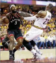  ?? ASSOCIATED PRESS FILE ?? Toronto Raptors’ James Johnson (3) collides with Cleveland Cavaliers’ LeBron James (23) during Game 5 of the 2016 NBA basketball Eastern Conference finals.