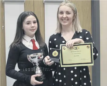  ?? ?? Macy Harper (S1) receives the award for Gymnast of the Year from coach Miss Gallagher