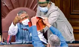  ?? —PTI ?? TMC MP Derek OBrien attempts to tear the rule book as ruckus erupts in the Rajya Sabha over agricultur­e related bills, during the ongoing monsoon session, at Parliament House in New Delhi on Sunday.
