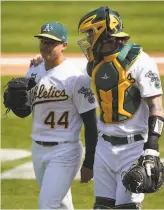  ?? Santiago Mejia / The Chronicle ?? A’s starter Jesus Luzardo heads back to the dugout with catcher Jonah Heim between innings of Saturday’s 60 victory over the Giants. Luzardo struck out seven and gave up five hits in six innings, lowering his ERA to 3.86.