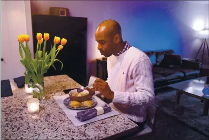  ?? PHOTOS BY CHRIS SWEDA — CHICAGO TRIBUNE ?? Demeko Taylor, a real estate agent who lives in Chicago’s Gold Coast neighborho­od, dines on a chicken pot pie meal he ordered from Tovala, one of many meal-kit companies experienci­ng a surge in demand during stay-at-home orders.