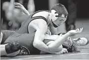  ?? [PHOTO BY SARAH PHIPPS, THE OKLAHOMAN] ?? Tuttle’s Ryder Ramsey (top), shown here during the state dual wrestling tournament in February, won an individual title in the Kansas City Stampede last weekend.